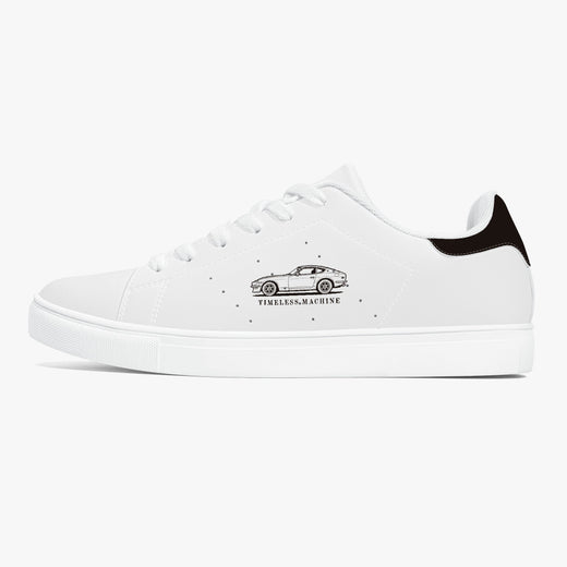 Side profile view of the left sneaker in smooth white leather, showcasing the vintage car graphic, black heel tab detail, white laces, and flat white rubber cupsole facing right.