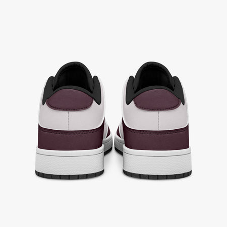Rear view of burgundy and pale pink sneakers showing dark burgundy heel overlays, pale pink collar panels, and black interior collars above white midsoles.