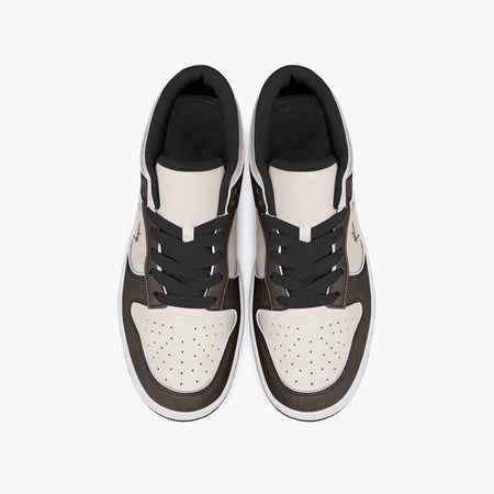 Overhead view of dark brown and cream sneakers displaying black laces, black padded collar lining, and perforated cream leather toe boxes.