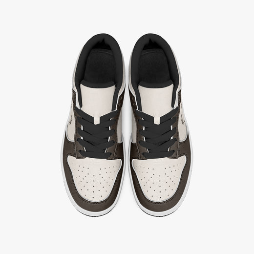Overhead view of dark brown and cream sneakers displaying black laces, black padded collar lining, and perforated cream leather toe boxes.