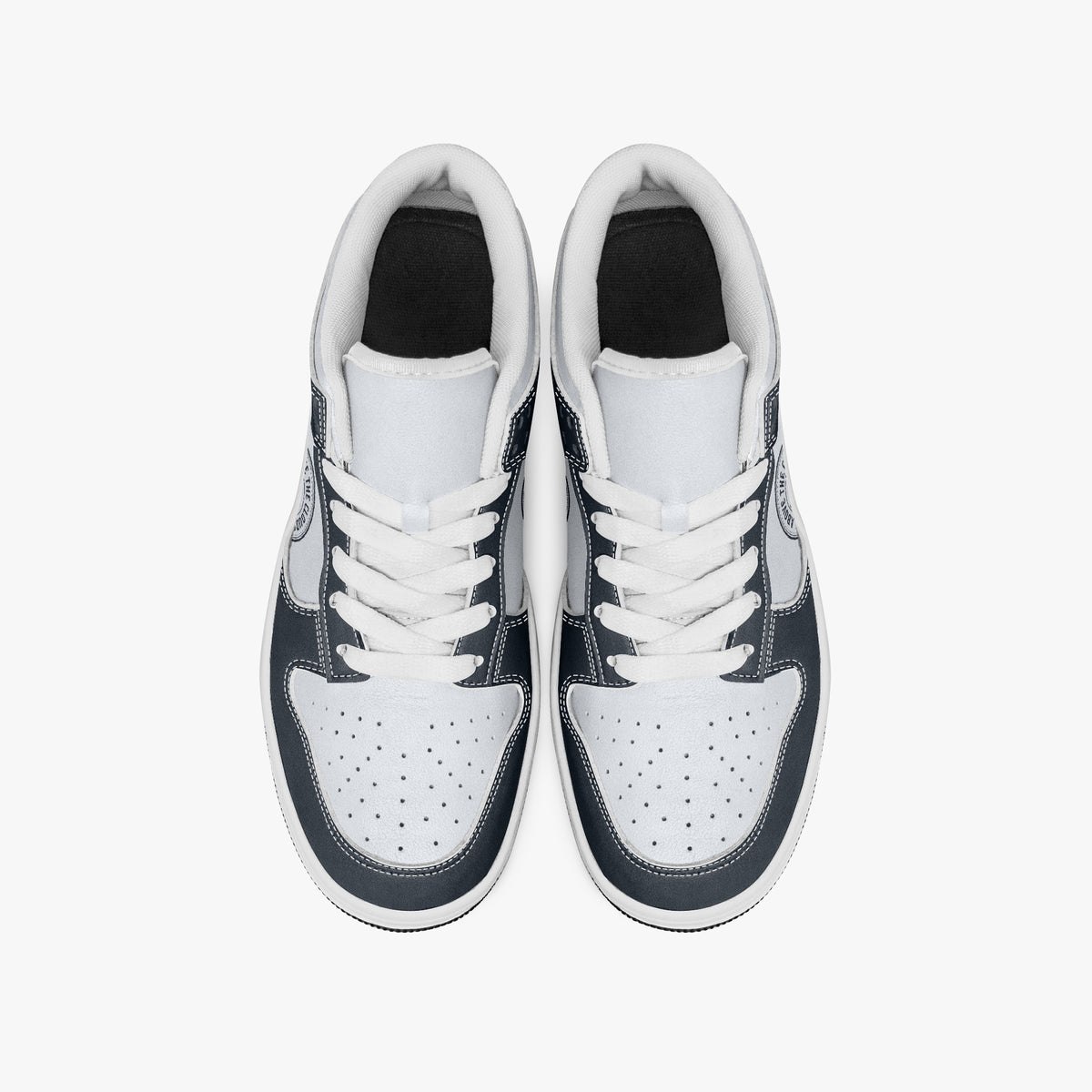 Overhead view of navy blue and off-white sneakers showing clean white laces, white padded collar lining, and perforated white leather toe boxes.