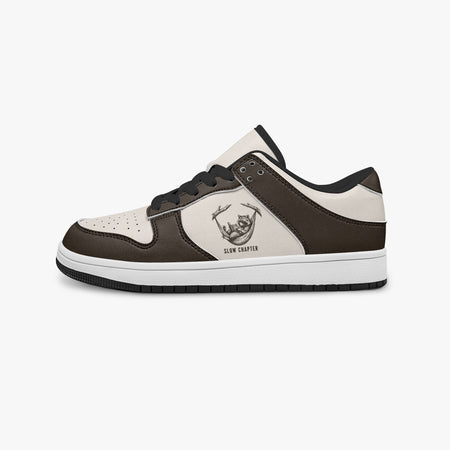 Side profile view of the left sneaker highlighting the dark brown leather panels, raccoon in hammock graphic with "SLOW CHAPTER", black interior lining, and flat rubber sole facing right.