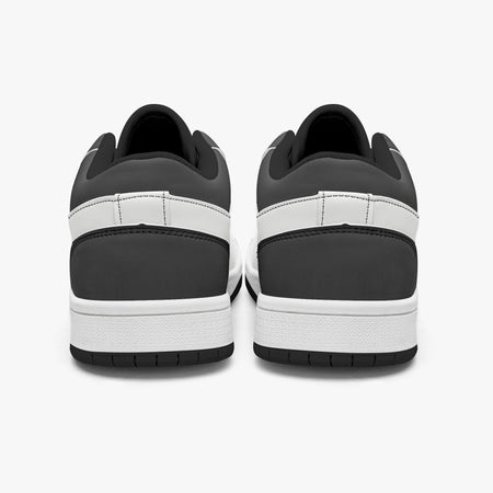 Rear view of black and white sneakers showing dark charcoal heel overlays, white leather collar panels, black interior collar lining, and white midsoles above black outsoles.