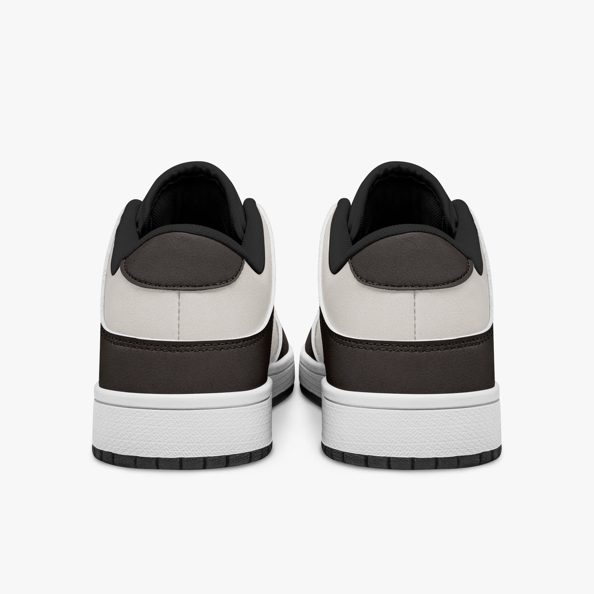Rear view of dark brown and cream sneakers showing dark brown heel overlays, off-white leather collars, and black interior collar lining above white midsoles.