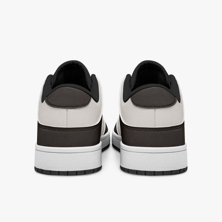 Rear view of dark brown and cream sneakers showing dark brown heel overlays, off-white leather collars, and black interior collar lining above white midsoles.