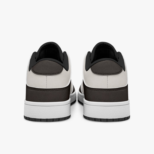 Rear view of dark brown and cream sneakers showing dark brown heel overlays, off-white leather collars, and black interior collar lining above white midsoles.