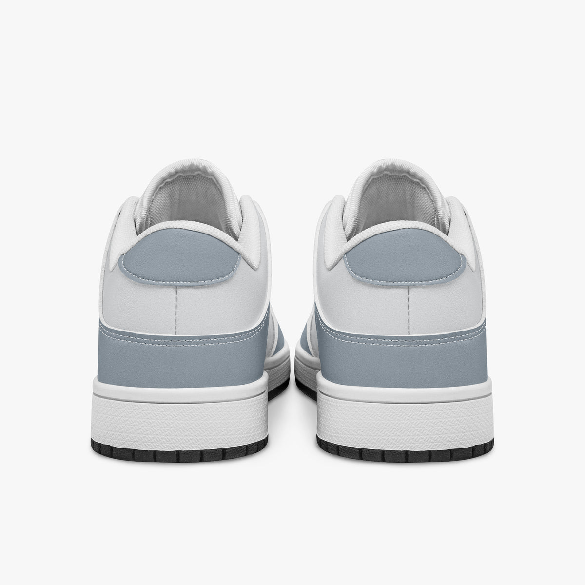 Rear view of slate blue-grey and white sneakers displaying blue-grey heel overlays, white leather collar panels, and two-tone white and black rubber outsoles.
