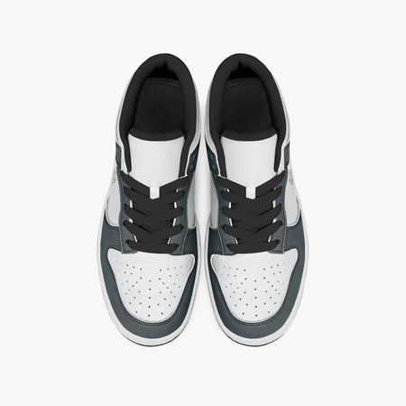 Overhead view of slate blue-grey and white sneakers displaying black laces, black padded collar lining, and perforated white leather toe boxes.