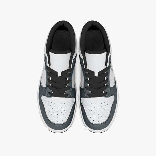 Overhead view of slate blue-grey and white sneakers displaying black laces, black padded collar lining, and perforated white leather toe boxes.