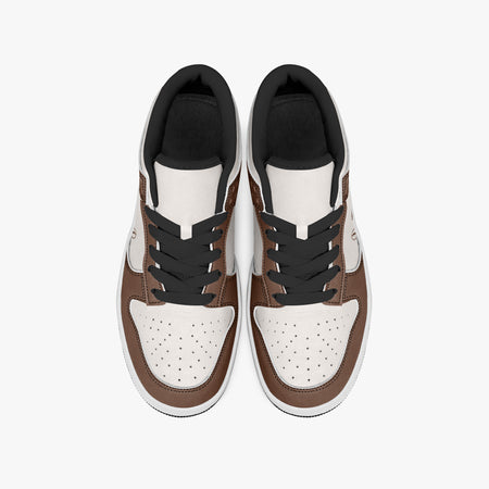 Overhead view of brown and cream sneakers displaying black laces, black padded collar lining, and perforated off-white leather toe boxes.