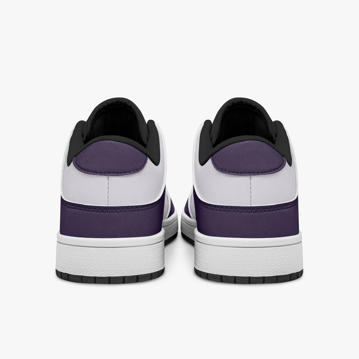 Rear view of deep purple and white sneakers displaying purple heel overlays, white leather collars, and two-tone rubber outsoles.