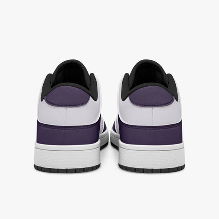 Rear view of deep purple and white sneakers displaying purple heel overlays, white leather collars, and two-tone rubber outsoles.