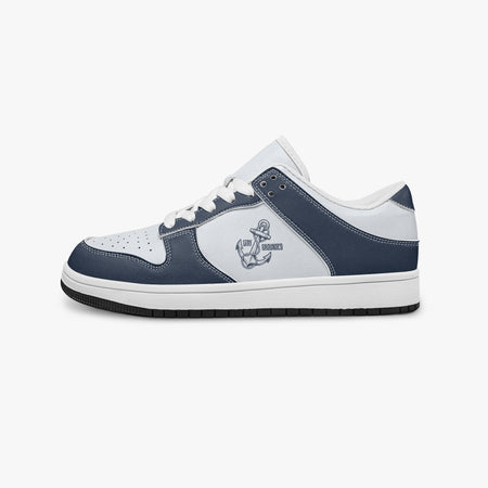 Side profile view of the left sneaker in navy blue and white, highlighting the anchor graphic, white laces, white interior collar, and flat rubber sole.