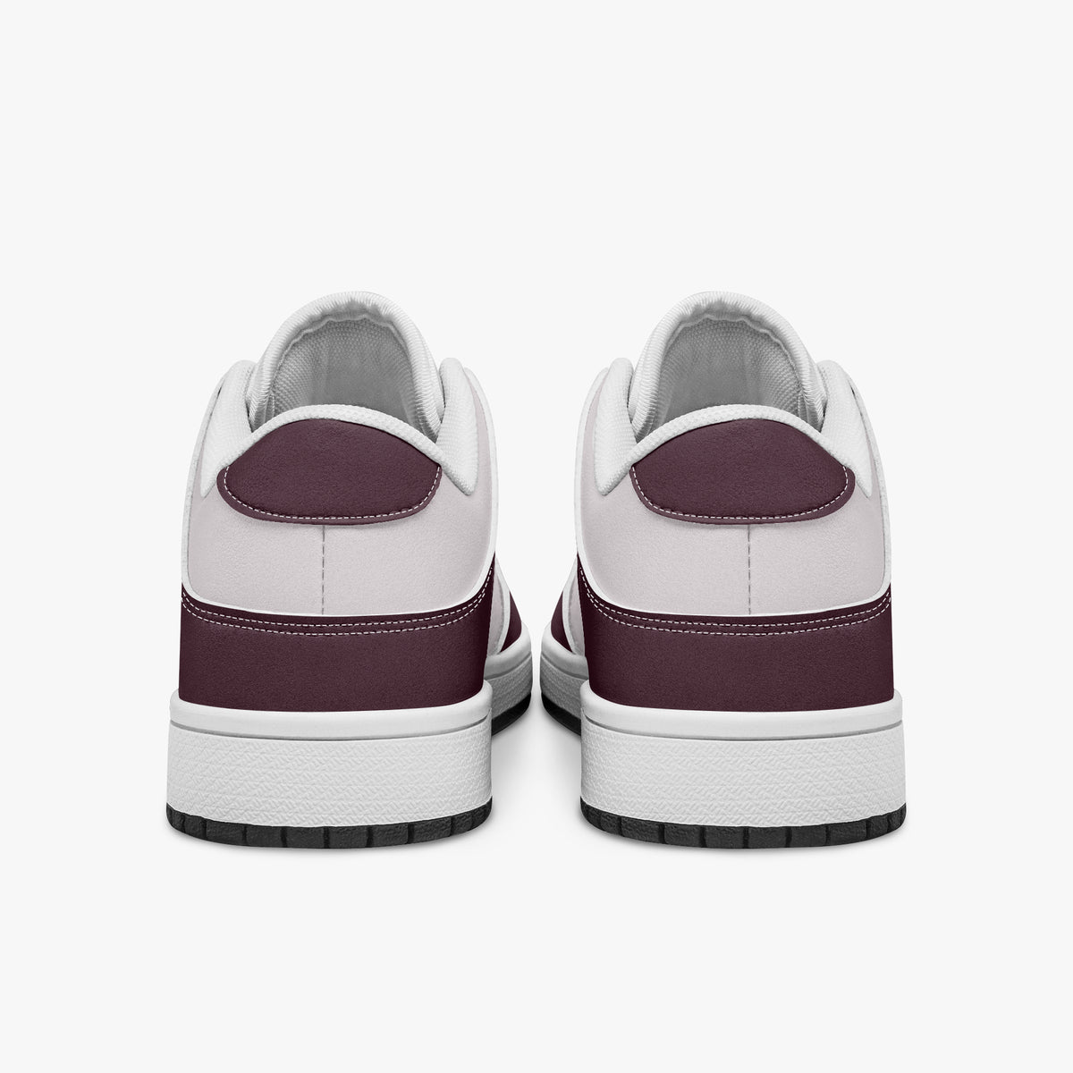 Rear view of burgundy and pale pink sneakers displaying deep burgundy heel overlays, pale pink collar panels, and two-tone white and black rubber outsoles.