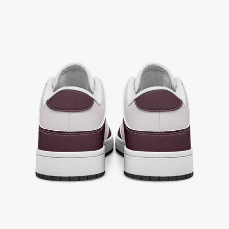 Rear view of burgundy and pale pink sneakers displaying deep burgundy heel overlays, pale pink collar panels, and two-tone white and black rubber outsoles.