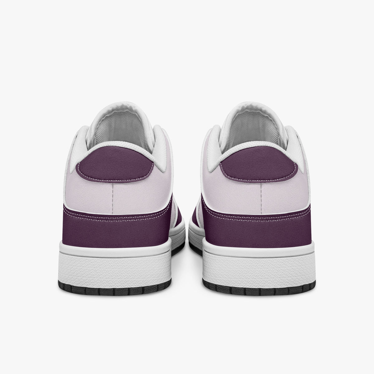 Rear view of plum and lilac sneakers displaying plum purple heel overlays, pale lilac collar panels, and two-tone white and black rubber outsoles.