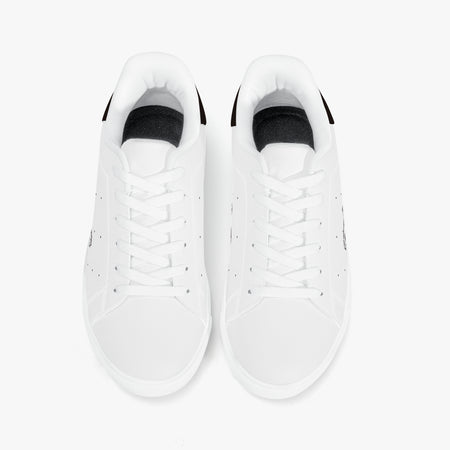 Overhead view of white leather sneakers showing clean white laces, white interior linings, and smooth white round toe caps.