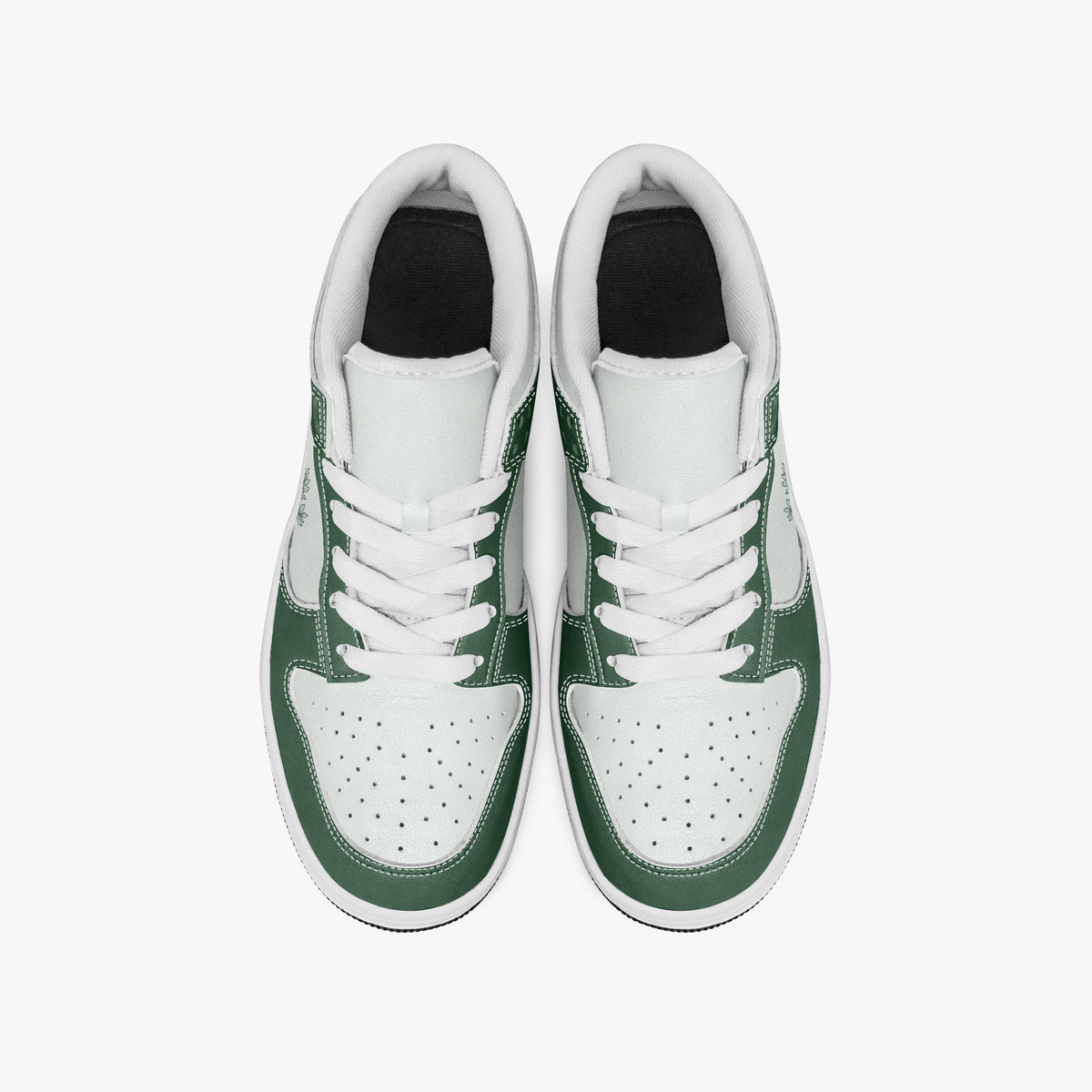 Overhead view of forest green and white sneakers showing clean white laces, white padded collar lining, and perforated white leather toe boxes.