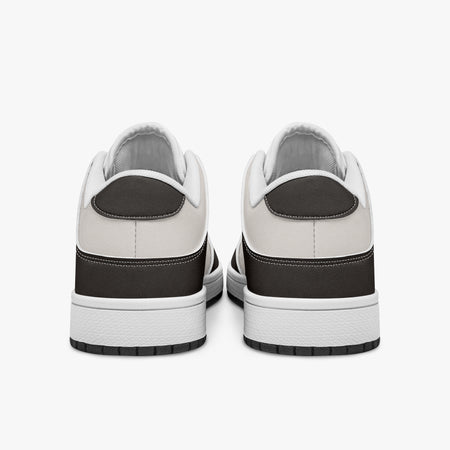 Rear view of dark brown and cream sneakers displaying espresso brown heel overlays, off-white leather collar panels, and two-tone white and black rubber outsoles.