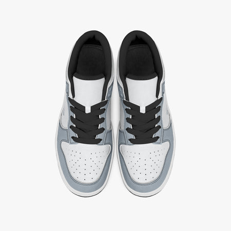 Overhead view of slate blue-grey and white sneakers displaying black laces, black padded collar lining, and perforated white leather toe boxes.