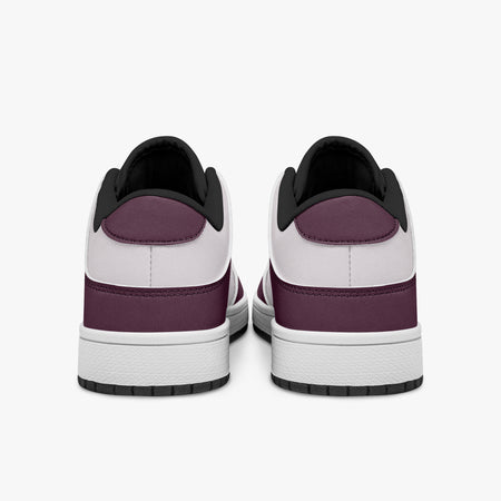 Rear view of burgundy and pale pink sneakers showing dark burgundy heel overlays, pale pink collar panels, and black interior collars above white midsoles.