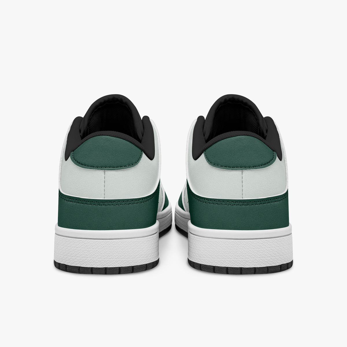 Rear view of forest green and white sneakers showing dark green heel overlays, white leather collars, and black interior collar lining above white midsoles.