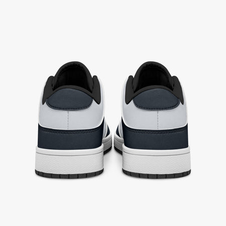 Rear view of navy blue and off-white sneakers showing dark navy heel overlays, white leather collars, and black interior collar lining above white midsoles.