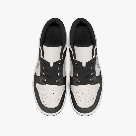 Overhead view of dark brown and cream sneakers displaying black laces, black padded collar lining, and perforated cream leather toe boxes.