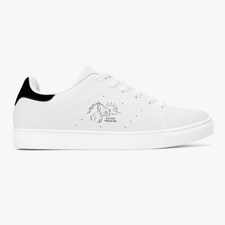 A white low-top sneaker with a black heel tab, white laces, and a black line-art lion graphic on the side with the text WILD HEART,PEACEFUL MIND