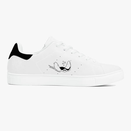 A white low-top sneaker with a black heel tab, white laces, and a black cartoon bird graphic on the side, set against a light gray background.