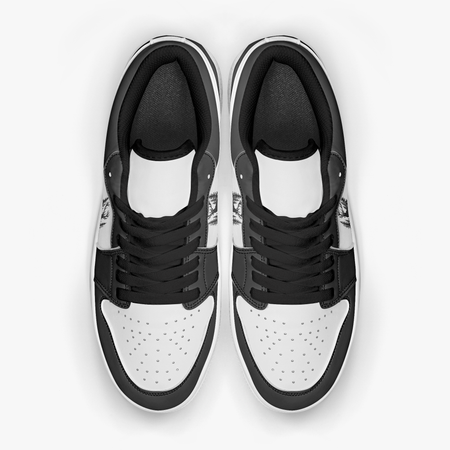 Overhead view of black and white sneakers displaying black laces, black padded collar lining, and perforated white leather toe boxes.