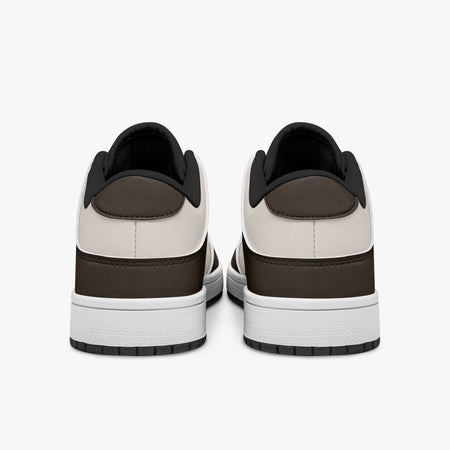 Rear view of dark brown and cream sneakers showing espresso brown heel overlays, off-white leather collar panels, and black interior collar lining above white midsoles.