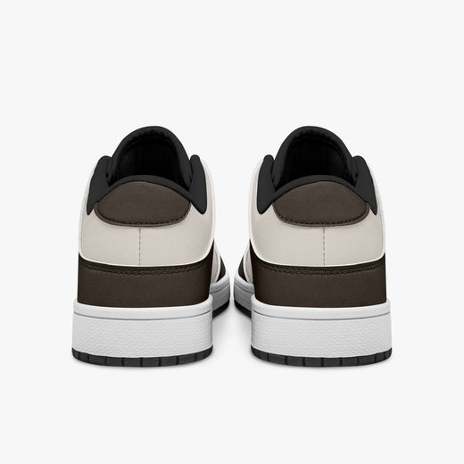 Rear view of dark brown and cream sneakers showing espresso brown heel overlays, off-white leather collar panels, and black interior collar lining above white midsoles.