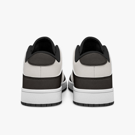 Rear view of dark brown and cream sneakers showing dark brown heel overlays, off-white leather collars, and black interior collar lining above white midsoles.