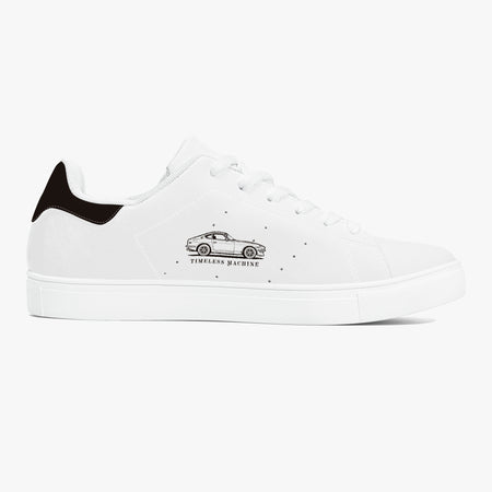 Side profile view of the right sneaker displaying the "TIMELESS MACHINE" classic coupe car illustration, tonal white stitching, and matching white sole facing right.