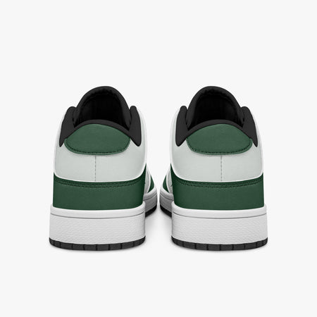 Rear view of forest green and white sneakers showing dark green heel overlays, white leather collars, and black interior collar lining above white midsoles.