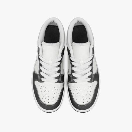Overhead view of black and white sneakers showing clean white laces, white padded collar lining, and perforated white leather toe boxes.