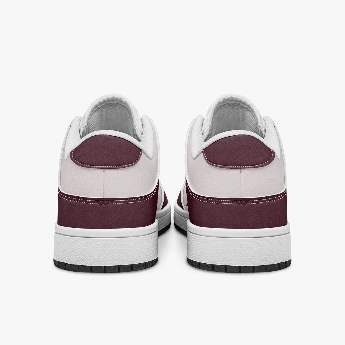 Rear view of burgundy and pale pink sneakers displaying deep burgundy heel overlays, pale pink collar panels, and two-tone white and black rubber outsoles.