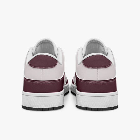 Rear view of burgundy and pale pink sneakers displaying deep burgundy heel overlays, pale pink collar panels, and two-tone white and black rubber outsoles.