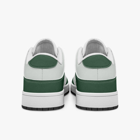Rear view of forest green and white sneakers displaying dark green heel overlays, white leather collar panels, and two-tone white and black rubber outsoles.