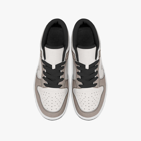 Overhead view of taupe and off-white sneakers displaying black laces, black padded collar lining, and perforated off-white leather toe boxes.