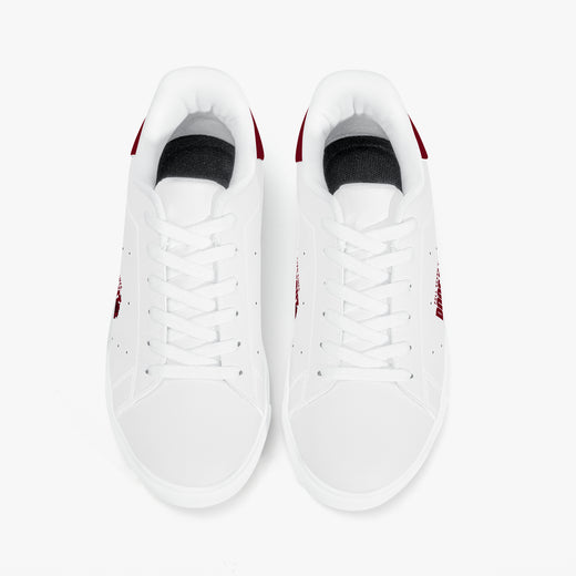 A pair of white low-top sneakers shown from a top-down view on a clean white background. The sneakers feature white laces, white leather or synthetic uppers, black inner lining, and small red accents on the heel and side.