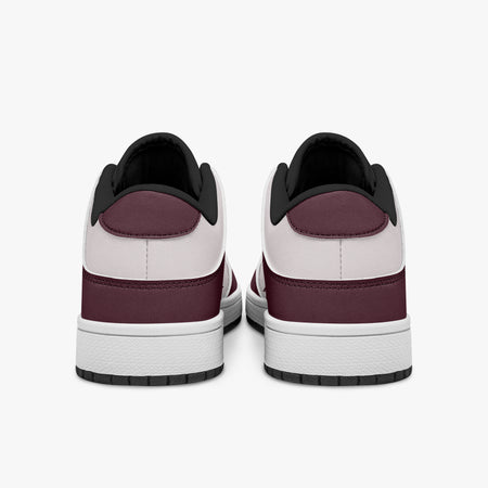 Rear view of burgundy and pale pink sneakers showing dark burgundy heel overlays, pale pink collar panels, and black interior collars above white midsoles.