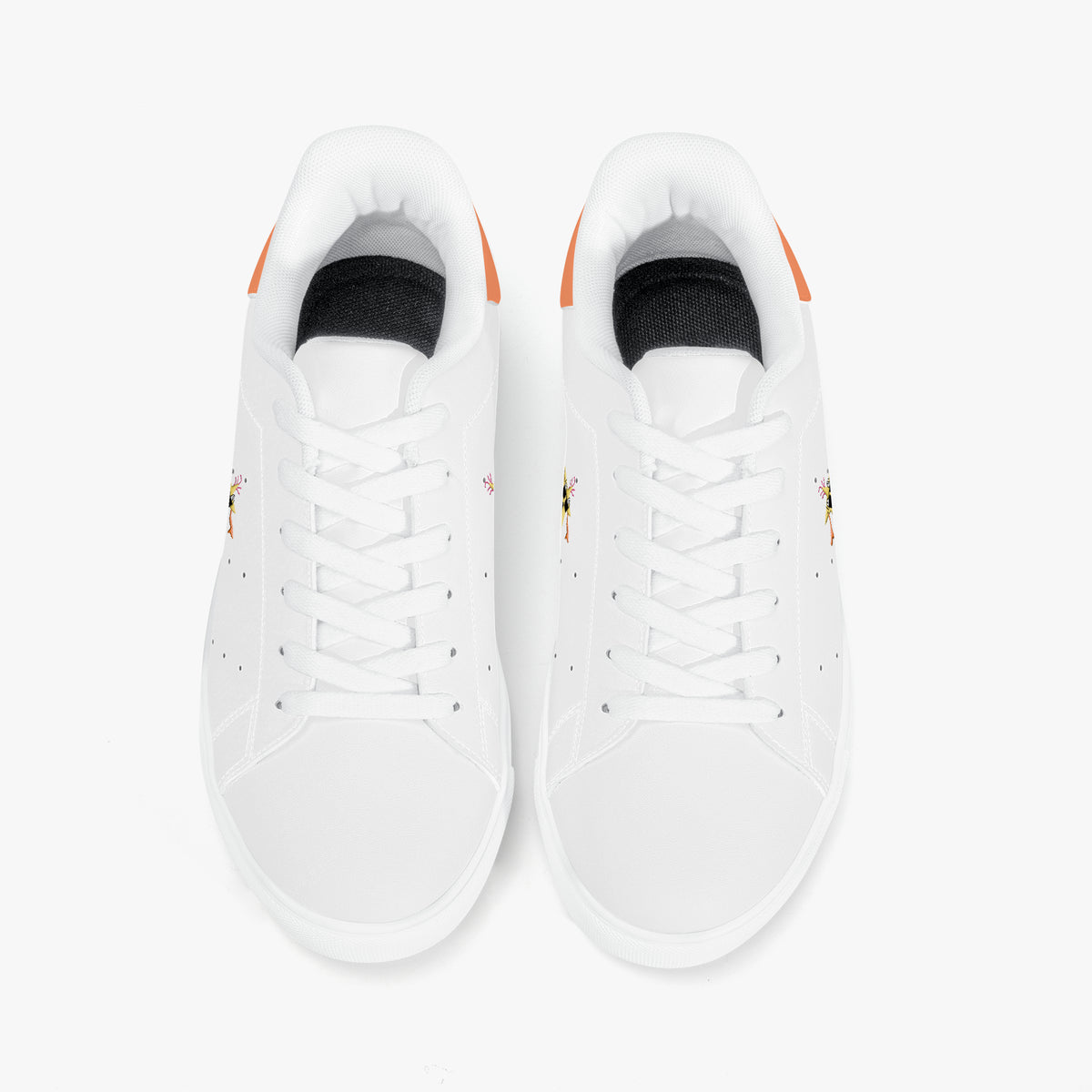A pair of white low-top sneakers shown from a top-down view on a clean white background. The shoes feature white laces, a black interior lining, and small orange heel accents.