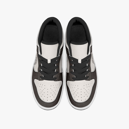 Overhead view of dark brown and cream sneakers displaying black laces, black padded collar lining, and perforated cream leather toe boxes.