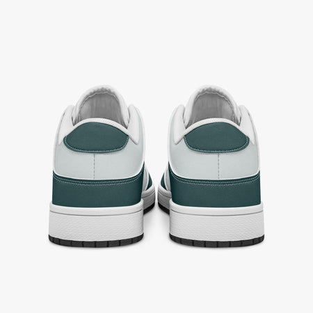Rear view of the sneakers displaying deep teal heel overlays, white leather collar trim, and two-tone white and black rubber outsoles.
