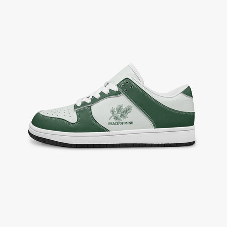 Side profile view of the left sneaker in forest green and white leather, highlighting the "PEACE OF MIND" botanical design, white laces, white interior lining, and flat rubber sole facing right.