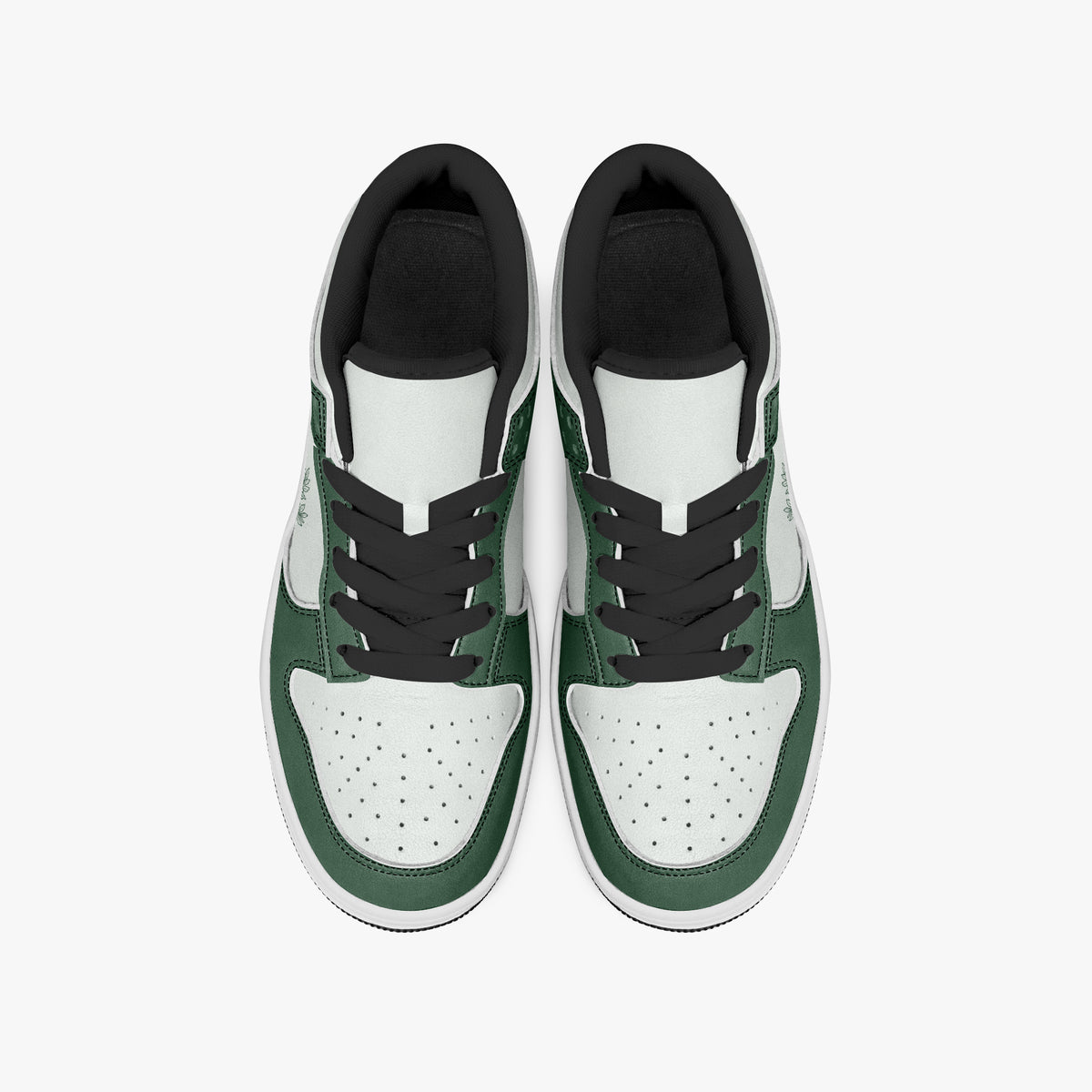 Overhead view of forest green and white sneakers displaying black laces, black padded collar lining, and perforated white leather toe boxes.