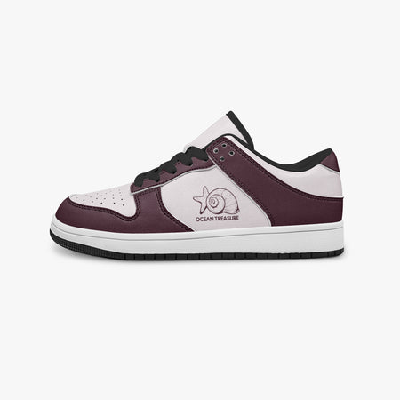 Side profile view of the left sneaker highlighting the burgundy leather panels, seashell emblem, black interior lining, and flat rubber sole facing right.