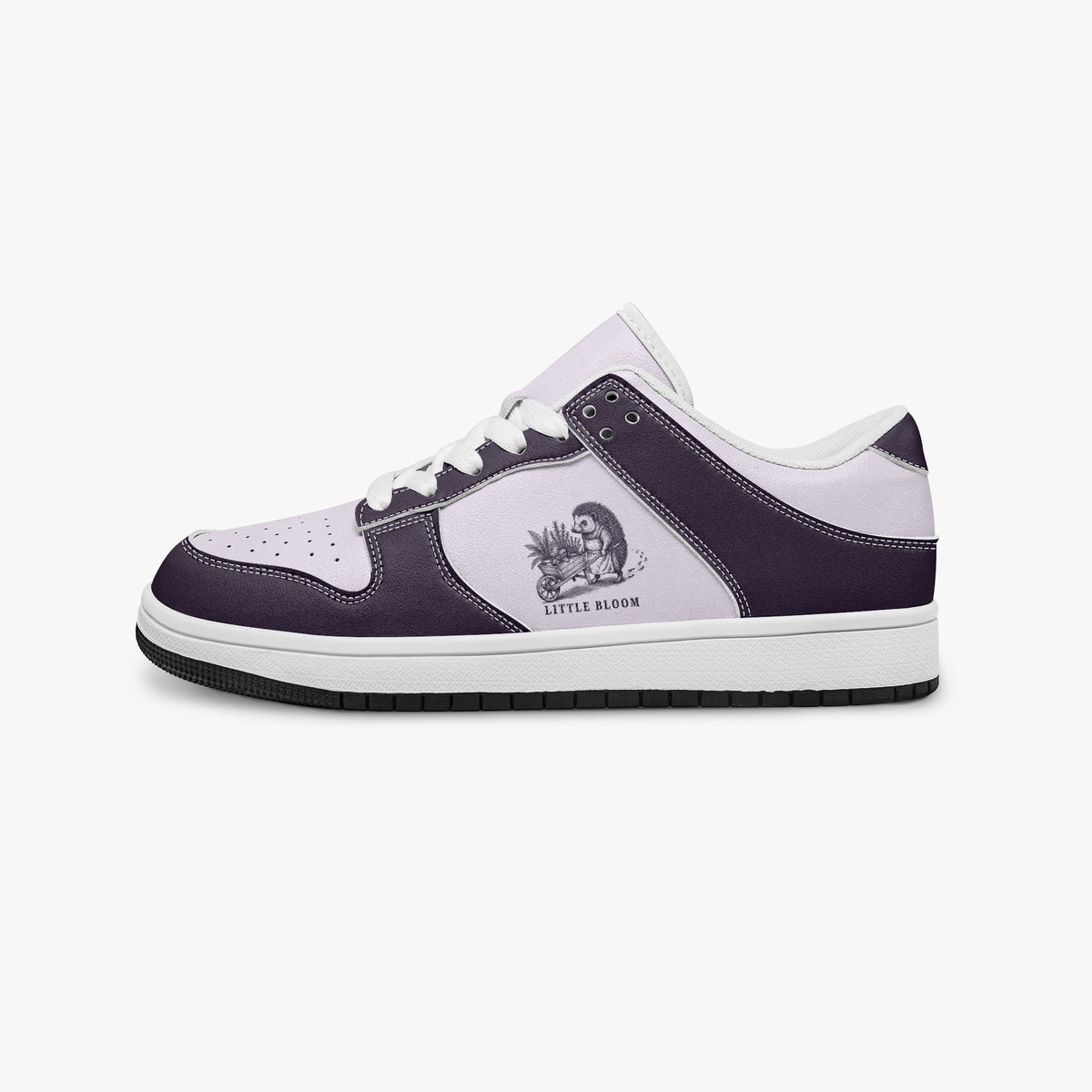 Side profile view of the left sneaker in deep plum purple and pale lilac leather, highlighting the "LITTLE BLOOM" hedgehog illustration, white laces, white interior lining, and flat rubber sole facing right.